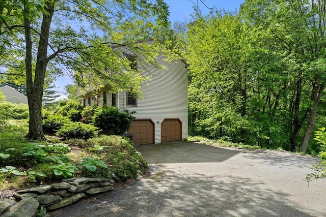 199 Old Westboro Rd, Grafton, MA 01536 - view of side of home featuring asphalt driveway and an attached garage