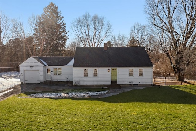 rear view of house featuring a yard and a garage