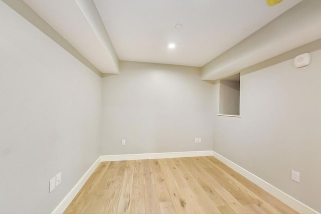 finished below grade area with baseboards, light wood finished floors, and recessed lighting