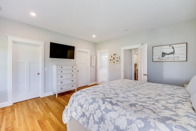bedroom with light wood-style flooring, baseboards, and recessed lighting