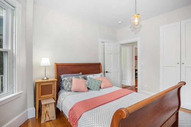 bedroom featuring baseboards and wood finished floors