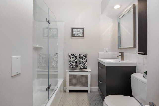 full bath featuring toilet, tile patterned floors, vanity, and  shower combination