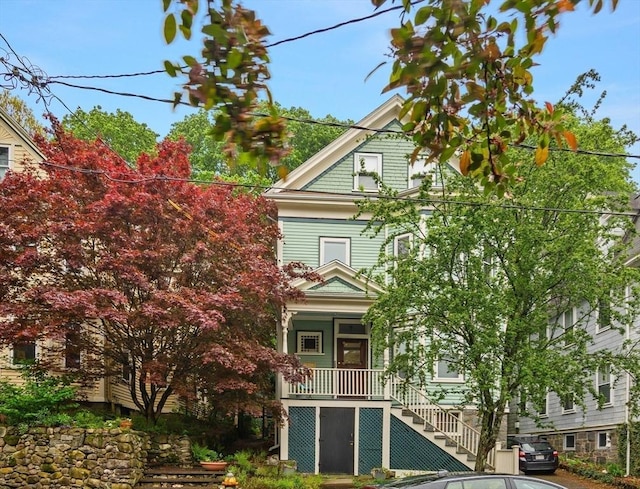 view of front of house with stairway and covered porch