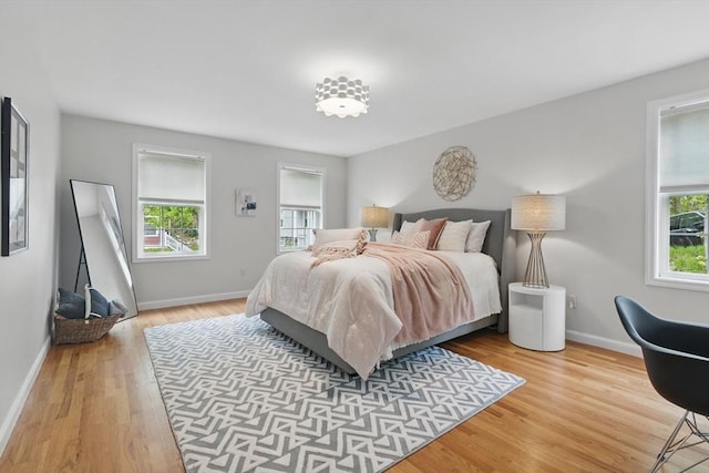 bedroom with wood finished floors and baseboards