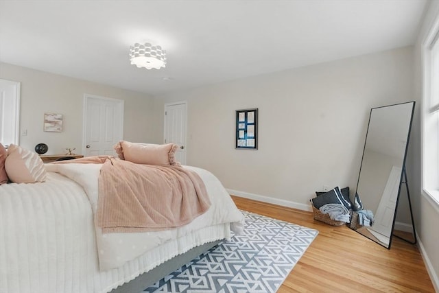 bedroom with baseboards and wood finished floors