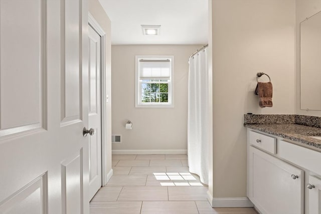 full bath with visible vents, baseboards, and vanity