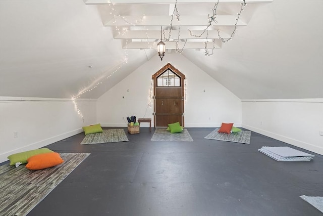bonus room with baseboards and lofted ceiling