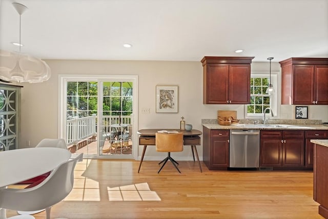 kitchen with dishwasher, plenty of natural light, pendant lighting, and light wood-style floors