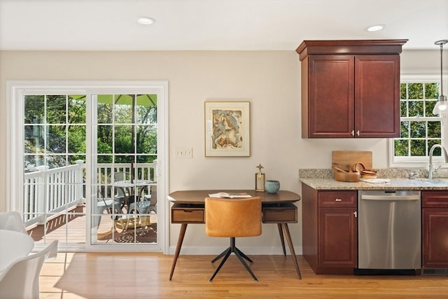 bar featuring recessed lighting, dishwasher, baseboards, a sink, and light wood-style floors