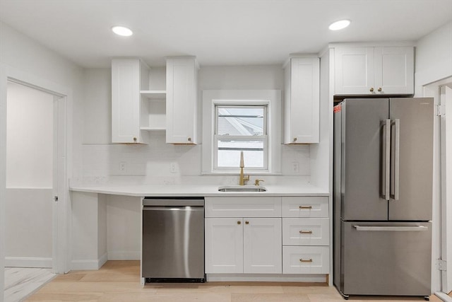 71 Water St, Quincy, MA 02169 - kitchen featuring appliances with stainless steel finishes, a sink, open shelves, white cabinetry, and light countertops