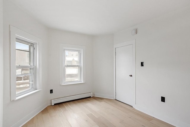 71 Water St, Quincy, MA 02169 - empty room featuring a baseboard radiator, plenty of natural light, light wood-style flooring, and baseboards