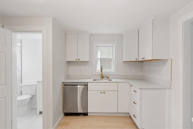 71 Water St, Quincy, MA 02169 - kitchen with stainless steel dishwasher, a sink, white cabinets, and light countertops
