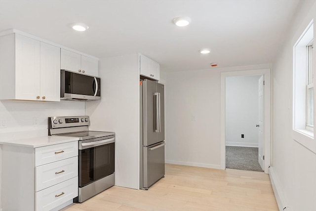 71 Water St, Quincy, MA 02169 - kitchen featuring appliances with stainless steel finishes, light wood-style floors, white cabinets, light countertops, and recessed lighting