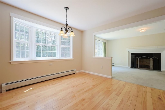 68 Dresser Hill Number 2 Rd, Dudley, MA 01571 - unfurnished dining area featuring baseboard heating, a chandelier, plenty of natural light, and wood finished floors