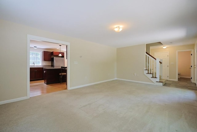 68 Dresser Hill Number 2 Rd, Dudley, MA 01571 - unfurnished living room with light colored carpet and stairway
