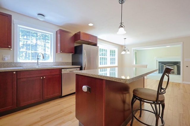 68 Dresser Hill Number 2 Rd, Dudley, MA 01571 - kitchen featuring stainless steel appliances, light wood-style floors, a kitchen bar, and a center island