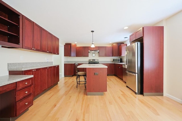 68 Dresser Hill Number 2 Rd, Dudley, MA 01571 - kitchen with appliances with stainless steel finishes, dark brown cabinets, light wood-style flooring, a kitchen island, and recessed lighting