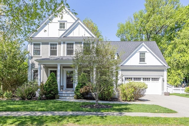 view of front of property with driveway, a porch, a garage, and a front lawn