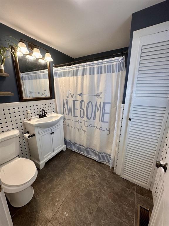 17 Walnut St, Gill, MA 01354 - full bathroom featuring toilet, vanity, and a shower with shower curtain
