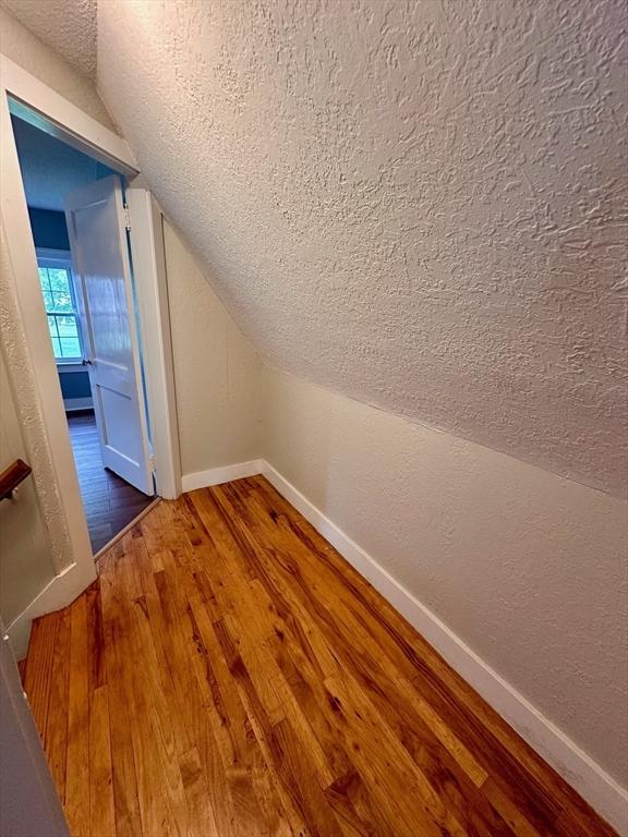 17 Walnut St, Gill, MA 01354 - bonus room featuring a textured ceiling, wood finished floors, lofted ceiling, baseboards, and a textured wall