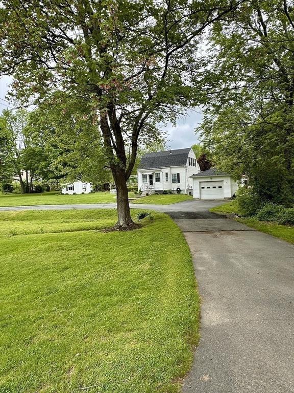 17 Walnut St, Gill, MA 01354 - view of front of house featuring asphalt driveway, a front lawn, and a garage