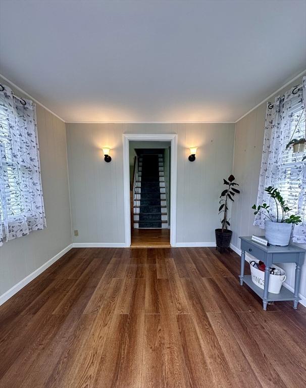 17 Walnut St, Gill, MA 01354 - spare room featuring wood finished floors, crown molding, stairway, and baseboards