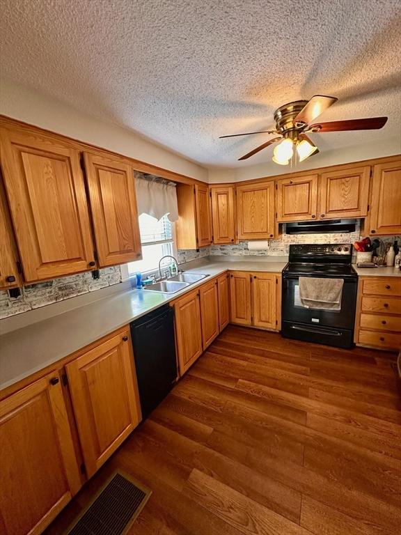17 Walnut St, Gill, MA 01354 - kitchen with black appliances, a sink, dark wood-style floors, a ceiling fan, and a textured ceiling