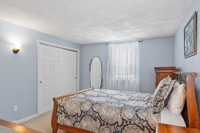 bedroom featuring light carpet and baseboards