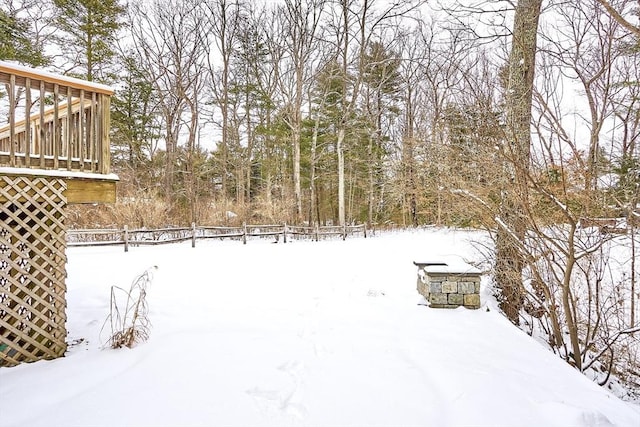 yard covered in snow featuring fence