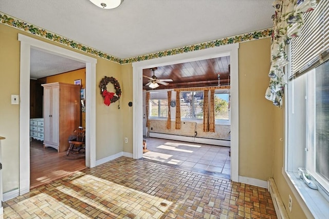 foyer entrance featuring a baseboard radiator, ceiling fan, and wood ceiling