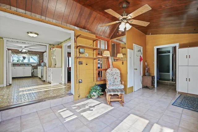 interior space with ceiling fan, light tile patterned floors, wooden ceiling, and lofted ceiling