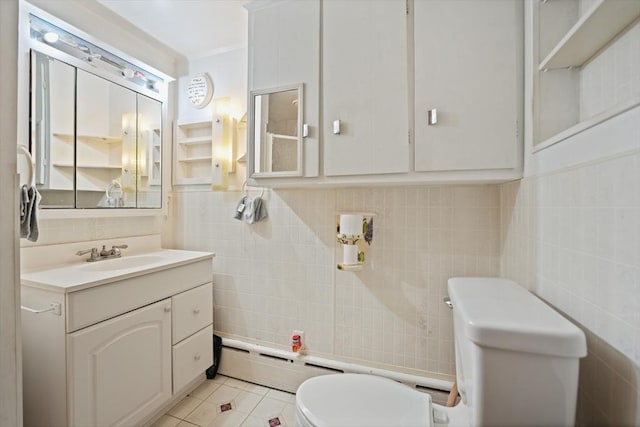 bathroom with tile patterned floors, toilet, a baseboard heating unit, and tile walls