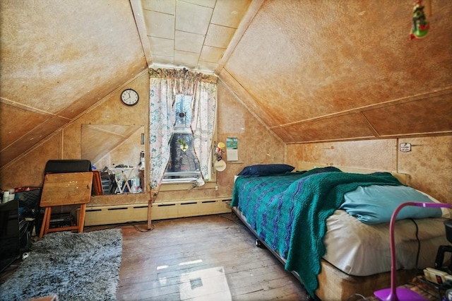 bedroom featuring a baseboard radiator, hardwood / wood-style floors, and vaulted ceiling