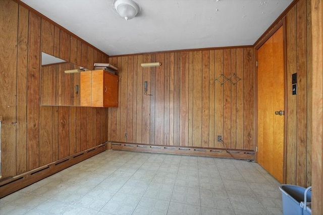 unfurnished room with wood walls