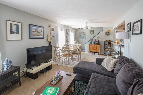 carpeted living room featuring a ceiling fan