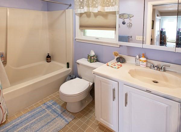 full bathroom featuring toilet, vanity, shower / tub combo, and tile patterned flooring