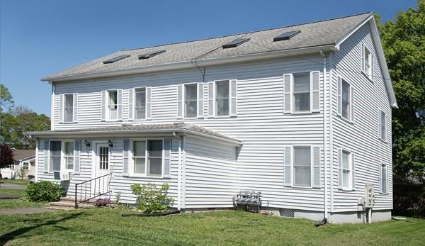 rear view of house with entry steps and a yard