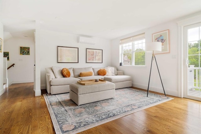 108 Central St, Ipswich, MA 01938 - living room featuring a wall mounted air conditioner, healthy amount of natural light, and wood finished floors