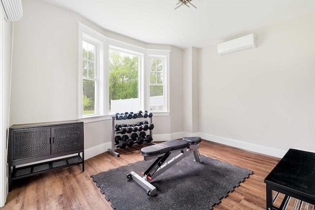 108 Central St, Ipswich, MA 01938 - exercise room with plenty of natural light, a wall mounted AC, and wood finished floors