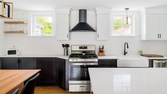 108 Central St, Ipswich, MA 01938 - kitchen featuring wall chimney exhaust hood, stainless steel gas range, light countertops, and white cabinetry