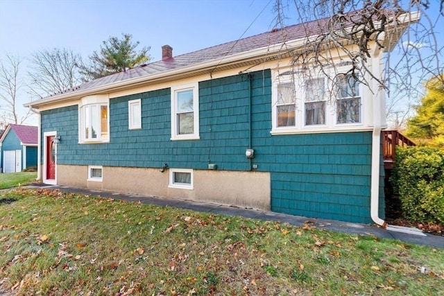 view of side of home with a lawn