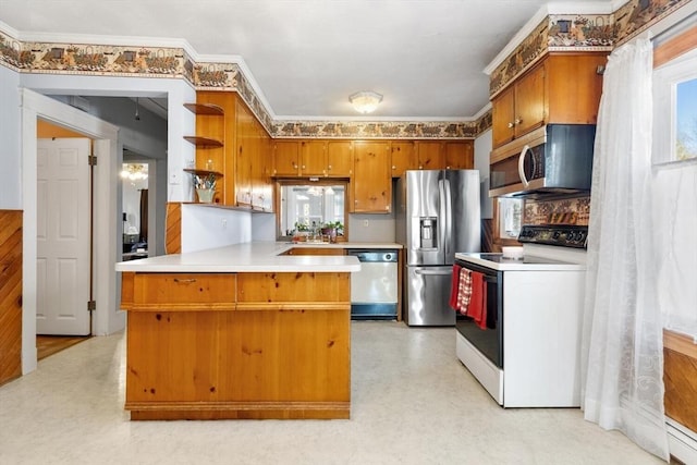 kitchen with plenty of natural light, appliances with stainless steel finishes, ornamental molding, and kitchen peninsula