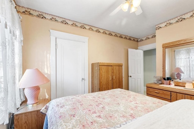 bedroom with ceiling fan and a closet