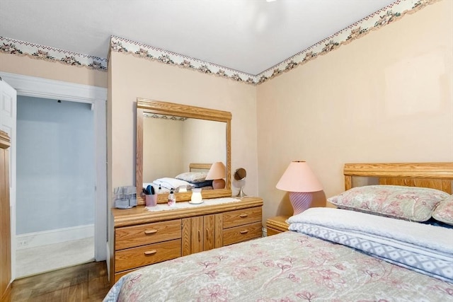 bedroom with dark wood-type flooring