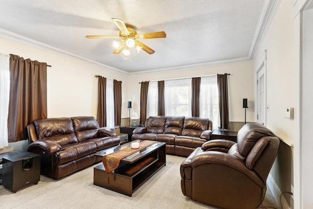 carpeted living room with ceiling fan and ornamental molding