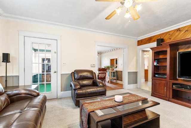 living room with ceiling fan, light carpet, and crown molding