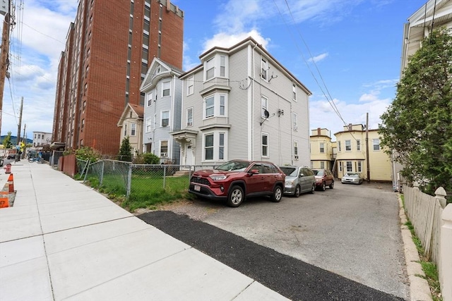 view of property featuring fence and a residential view