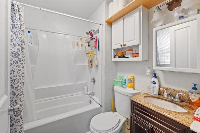 bathroom with vanity, shower / bath combo with shower curtain, and toilet