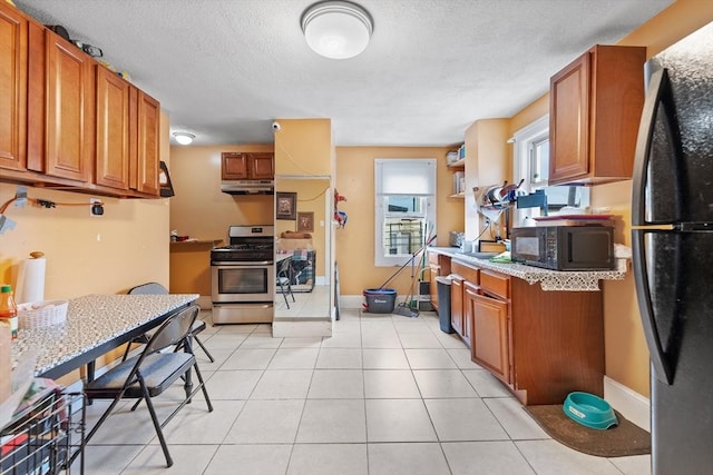 kitchen featuring black appliances, under cabinet range hood, brown cabinets, a textured ceiling, and open shelves
