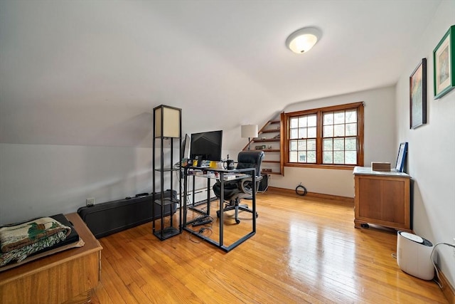 office space with light wood-style flooring and lofted ceiling